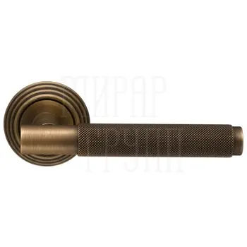 Дверная ручка Extreza 'TUBA' (Туба) 126 на круглой розетке R05 матовая бронза