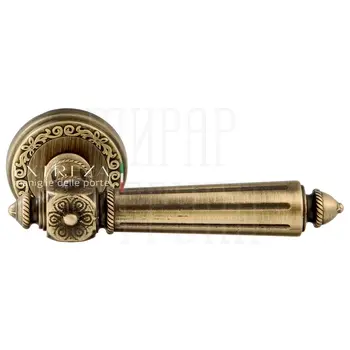 Дверная ручка Extreza 'Leon' (Леон) 303 на круглой розетке R06 матовая бронза